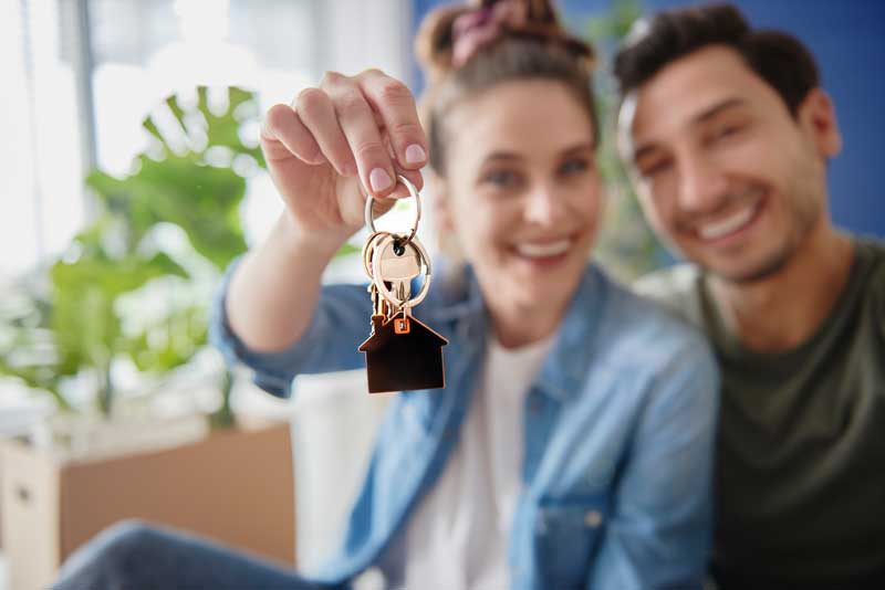 Couple holding keys to new house